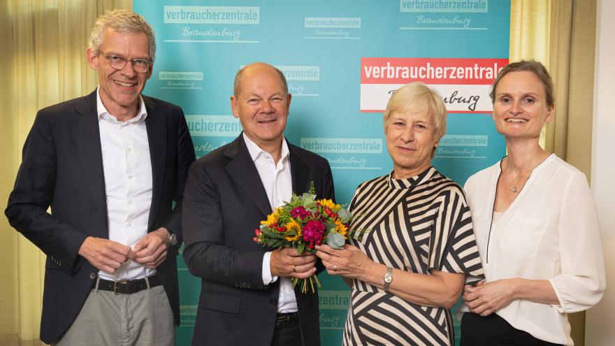 Olaf Scholz überreicht zu ihrer Verabschiedung Blumen an die langjährige Beratungsstellen-leiterin Sylvia Schönke in der Potsdamer Verbraucherzentrale, mit VZB-Geschäftsführer Christian A. Rumpke (l.) und Juristin Stefanie Kahnert (r.)
